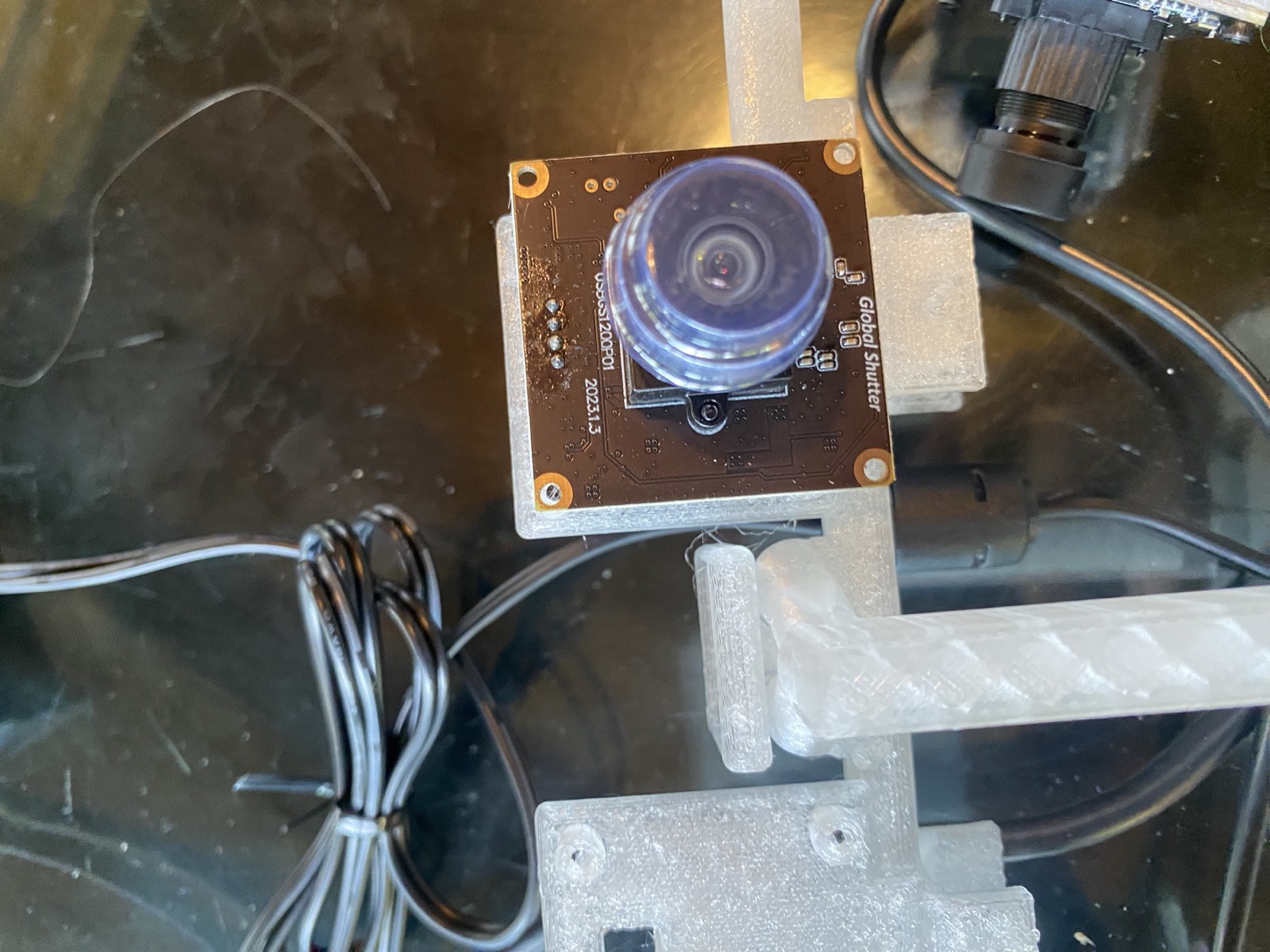 A small global-shutter camera board mounted on a printed boom